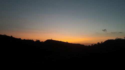 Silhouette of trees against sky at sunset