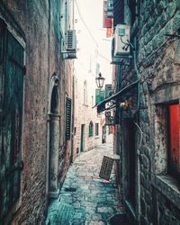 Narrow alley amidst buildings in city