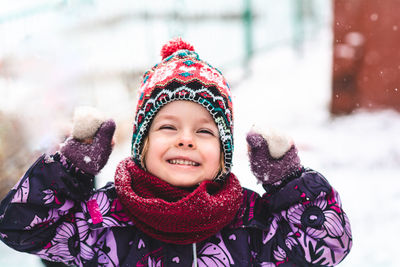 Happy and cheerful child outdoors in winter on the background of nature.