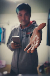 Midsection of man using mobile phone