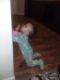 High angle view of girl lying on floor at home