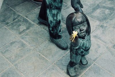 High angle view of dog sitting on tiled floor