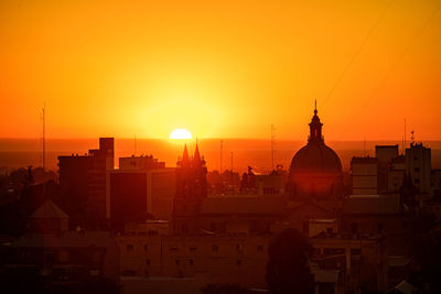 Buildings against sky during sunset