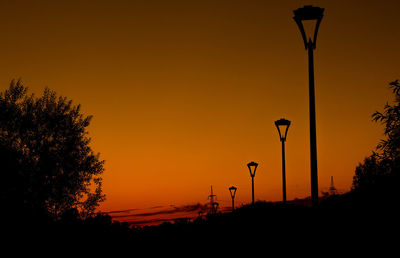 Silhouette street light against sky during sunset