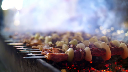 Grilled kebab cooking on metal skewer close up. roasted meat cooked at barbecue