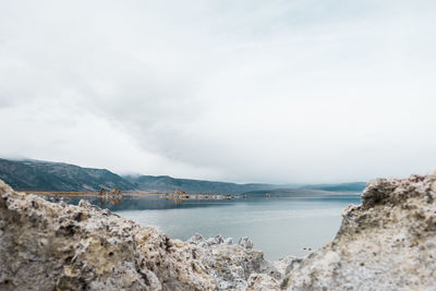 Scenic view of mono lake and mountains against sky
