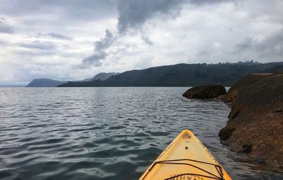 Scenic view of sea and mountains against sky