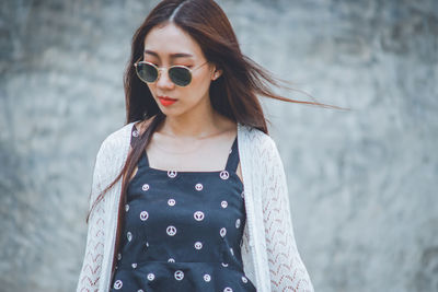 Portrait of woman wearing sunglasses standing outdoors