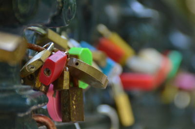 Close-up of padlocks hanging on wooden post