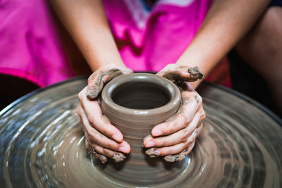 Close-up of artist making pot at workshop