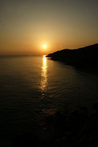 Scenic view of sea against romantic sky at sunset