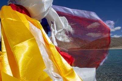 Close-up of multi colored flag in sea