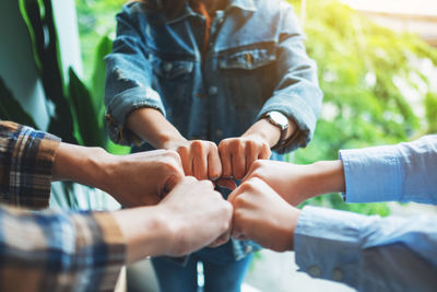 Midsection of woman holding hands
