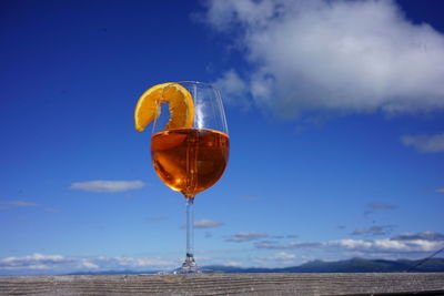 Close-up of drink on glass against sky