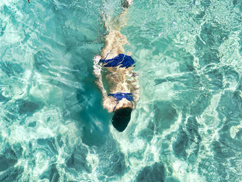 High angle view of man swimming in sea