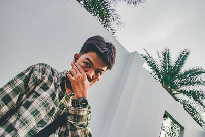 Portrait of young man against plants