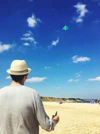 Rear view of man flying kite