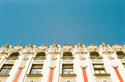 Low angle view of historical building against blue sky