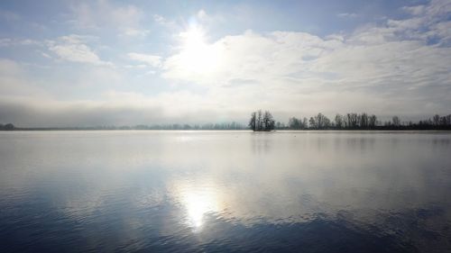 Scenic view of lake against sky during winter