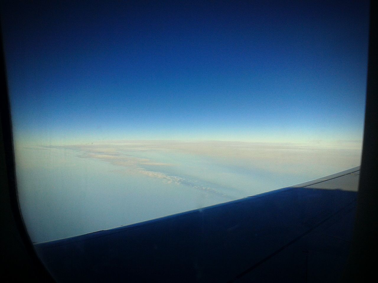 airplane, flying, transportation, air vehicle, blue, aircraft wing, part of, scenics, cloudscape, aerial view, cropped, mode of transport, clear sky, on the move, mid-air, window, tranquil scene, beauty in nature, tranquility, sky, idyllic, nature, majestic, cloud - sky, cloud, journey, day, outdoors, horizon, airplane wing