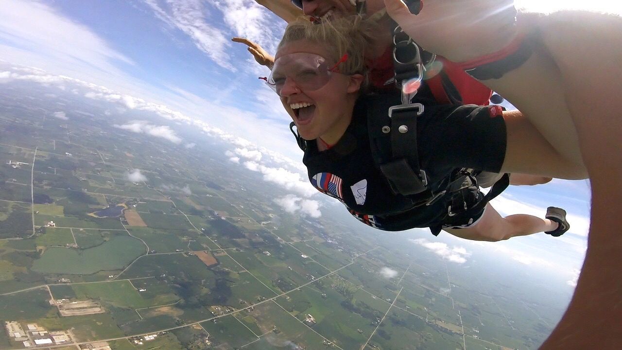 leisure activity, real people, two people, skydiving, mid-air, fun, sunlight, extreme sports, day, lifestyles, togetherness, sky, outdoors, boys, adventure, nature, water, smiling, fish-eye lens, parachute, people