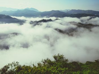 Scenic view of mountains against cloudy sky