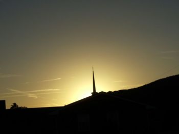 Low angle view of built structure at sunset