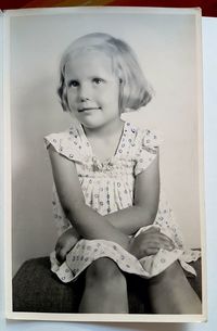 Portrait of smiling girl sitting at home