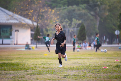 Full length of woman running on grass