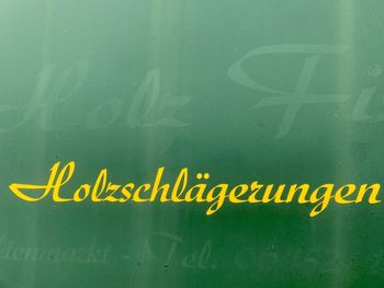 Close-up of yellow text on wall