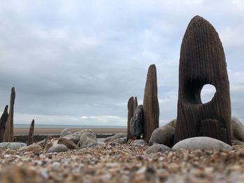 View of rocks on beach against sky