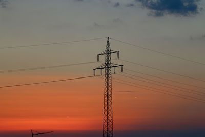 Low angle view of electricity pylon against sky