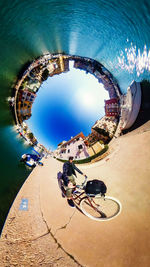 Ferris wheel in city against blue sky