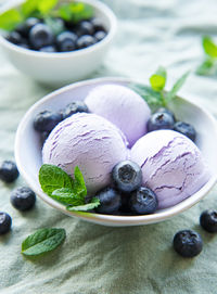 Homemade blueberry ice cream with fresh blueberries. sweet berry summer dessert. concrete background