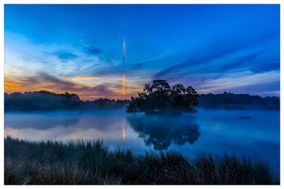 Scenic view of lake against blue sky