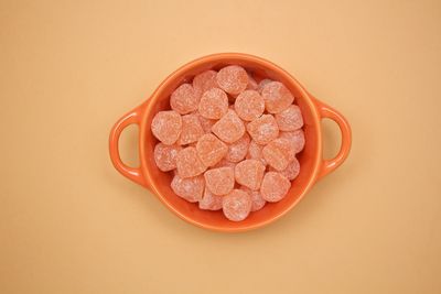 Directly above shot of orange cake against white background