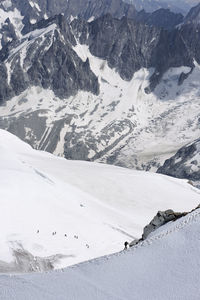 Views from la'aiguille du midi in chamonix, france. in the image climbers ascending mont blanc 