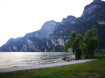 Scenic view of sea and mountains against sky