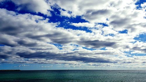 View of calm sea against cloudy sky