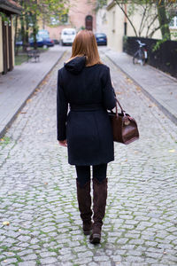 Rear view of woman walking on street