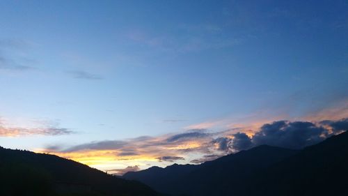 Scenic view of silhouette mountains against sky