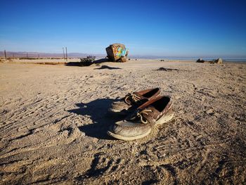 Abandoned sand on beach against clear sky