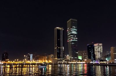 Low angle view of illuminated city lit up at night