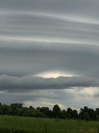 Scenic view of field against cloudy sky