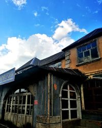 Low angle view of abandoned house against sky