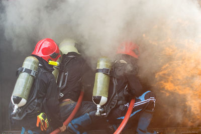 Firefighter, fire  a strong and brave firefighter injects water against the fierce fire.