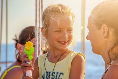 Portrait of happy girl holding camera
