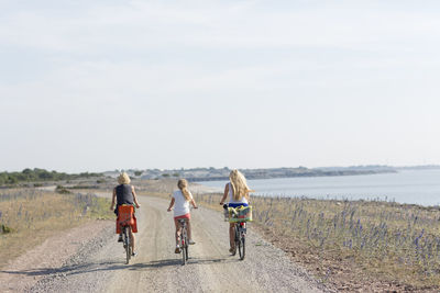 Mother with two daughters cycling