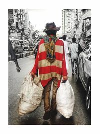 Rear view of man standing in city