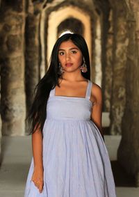 Portrait of a beautiful young woman standing outdoors